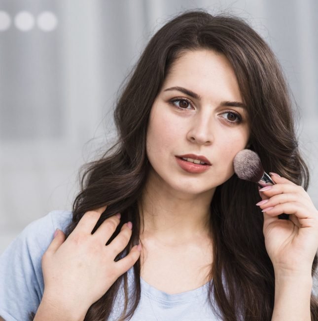 pensive-beautiful-woman-with-makeup-brush